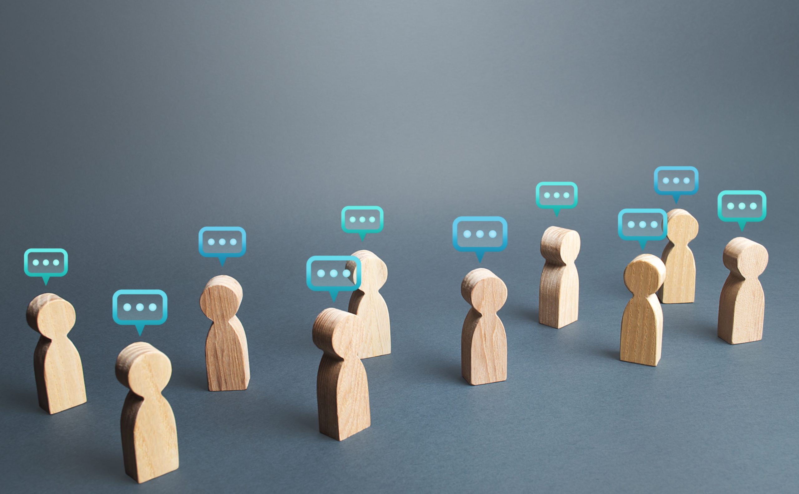 Tiny human avatars stand next to each other with comment bubbles above their heads.