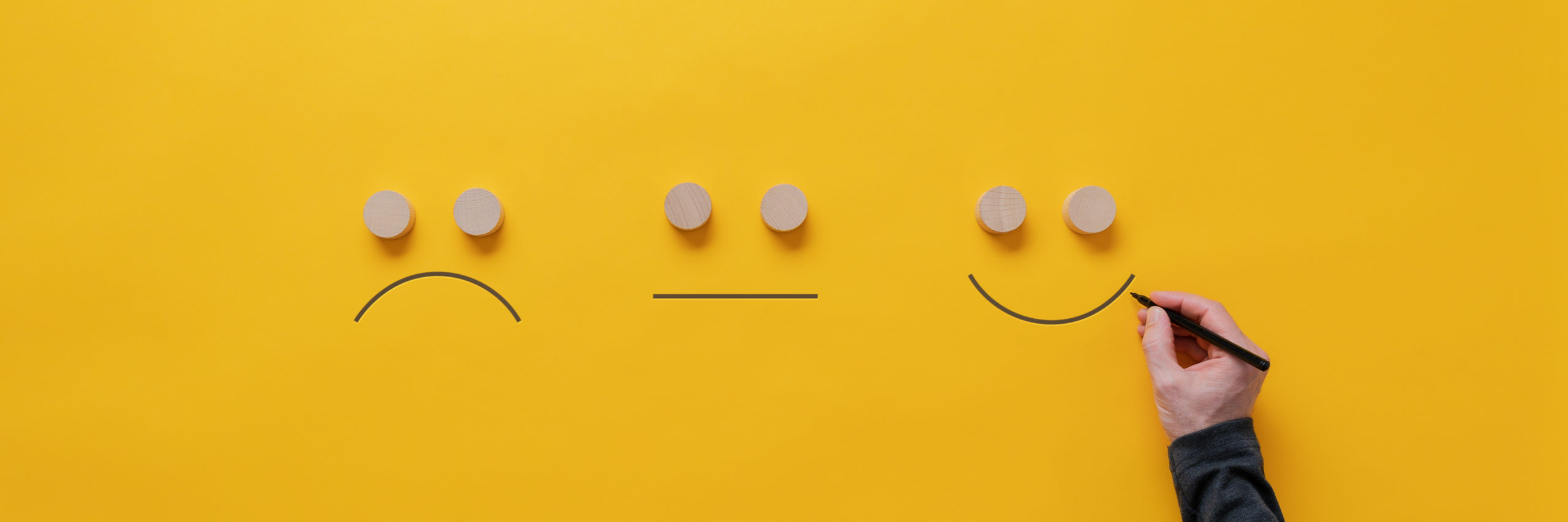 Smiling, sad and neutral emojis hand-drawn.