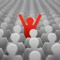 Large group of grey people icons with one red happy person icon
